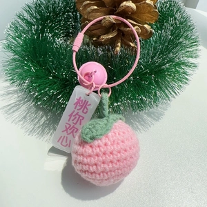 Handmade knitted pink peach keychain with green leaf and bell charm accessory