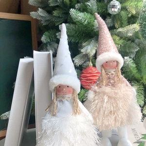 Close-up of plush angel dolls with sequins and soft feather skirts for Christmas decor