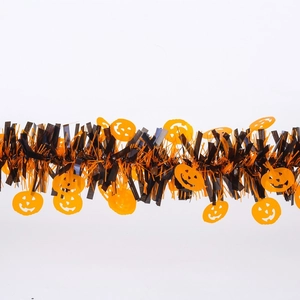 Detail of Halloween tinsel garland with orange pumpkin cutouts and black fringe