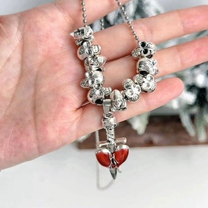 Gothic skull chain necklace with a red heart and silver sword pendant for Halloween party