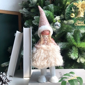 Detail of Christmas angel doll wearing a pink sequin hat and plush skirt decor