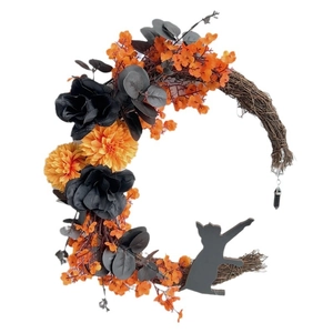 Halloween crescent moon wreath with dried twigs, orange flowers, and a black cat silhouette