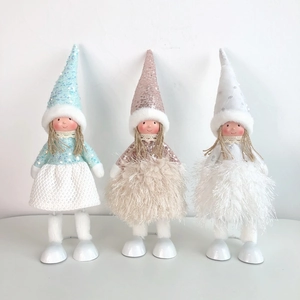Close-up of three festive angel dolls with sequin hats and plush dresses for Christmas decor