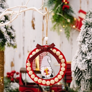 Detail of wooden Christmas gnome wreath with red base, plaid bow and festive wood beads