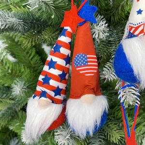 Detail of Fourth of July gnome ornaments with red white and blue patriotic patterns