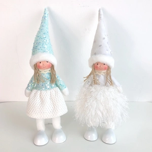 Macro detail of Christmas angel dolls featuring blue sequins and white feather texture