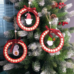 Red Christmas tree ornaments with wooden gnome pendants and buffalo plaid bows