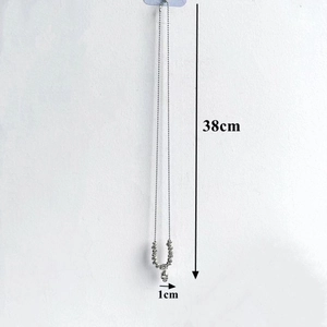 Detail view of silver bead chain necklace with 38cm length and 1cm pendant scale