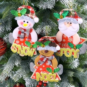 Detailed view of plush Snow, Joy, and Noel Christmas ornaments hanging on a pine tree