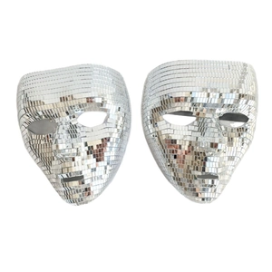 Close-up of two silver disco ball mirror masks for masquerade and party decorations