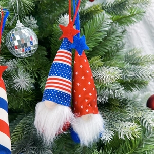 Detail of Independence Day faceless gnome plush ornaments hanging on a Christmas tree