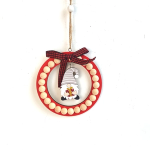 Detail of Christmas gnome ornament with red wooden bead ring and buffalo plaid bow
