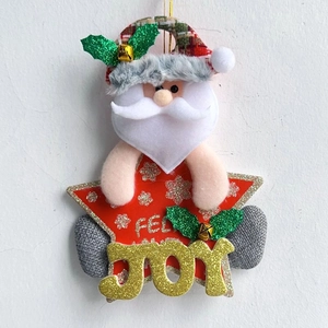 Detail of Santa Claus plush on a red star with gold glitter JOY text ornament