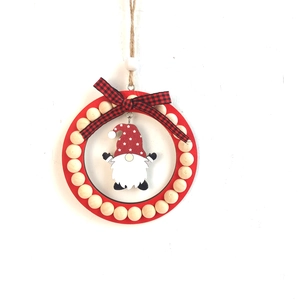 Detail of a Christmas gnome ornament with red wooden ring, wooden beads, and a plaid bow