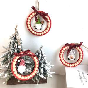 Detail of Christmas gnomes wooden hanging ornaments with red beads and plaid bows