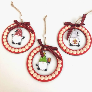Close-up of wooden Christmas gnome ornaments with red frames and buffalo plaid bows