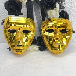 Close-up of golden disco ball mosaic mask set with shiny mirror tiles for parties