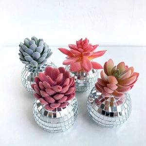 Close-up of four colorful faux succulents in reflective mirrored disco ball mini planters