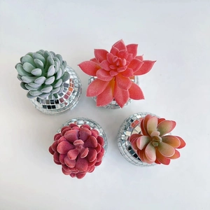 Top view of four artificial succulents in reflective mirror disco ball planter pots