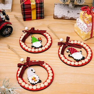 Close-up of three festive wooden gnome ornaments with red rings and beaded accents