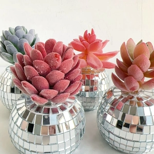 Close-up of artificial succulents in disco mirror ball pots for modern home decor