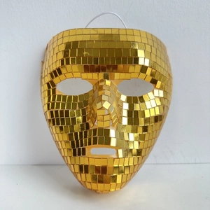 Macro shot of gold disco ball mirror mask texture with reflective square tiles