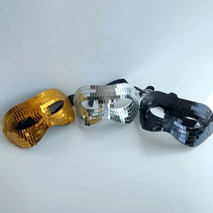 Detailed view of gold, silver and black mirror disco ball half-face party masks