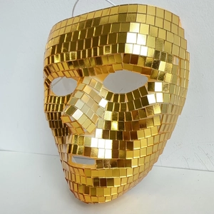Detailed close-up of golden disco mosaic mask with reflective mirror tiles for parties