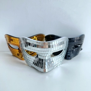 Close-up of gold silver and black disco mirror mosaic half-face party masks