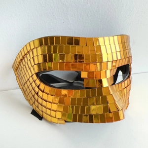 Macro shot of handmade gold mirror sequins on a disco-style reflective party mask detail
