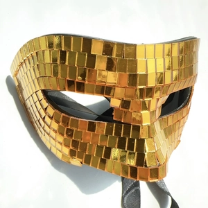 Detail of gold disco ball mask with reflective mirror mosaic tiles for Halloween party