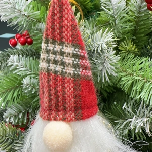 Close-up of Christmas faceless gnome ornament with red green plaid hat on tree