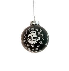 Detail of matte black pirate skull ornament with crossbones and silver metal cap hanger