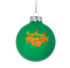 Close-up of a matte green Thanksgiving ornament ball with pumpkin and Happy Thanksgiving text