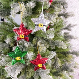 Close-up of Santa belt sequin star ornaments hanging on a green Christmas tree