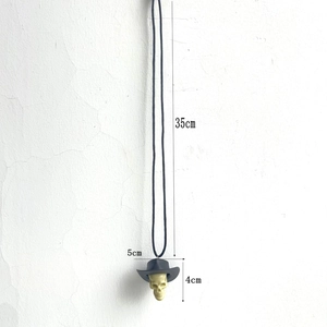 Detail showing skull pendant with cowboy hat dimensions including height and width markings