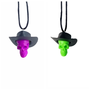 Detailed view of skull pendants wearing cowboy hats in purple and green resin