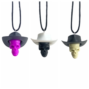 Detailed view of Halloween skull charms wearing western cowboy hats in three various colors