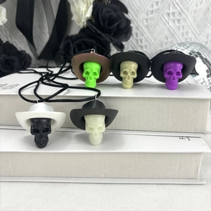 Detail of colorful skull cowboy hat pendant necklaces for Halloween party decoration