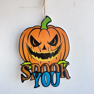 Detailed view of Halloween pumpkin door sign with Spook You text and rustic hanging rope