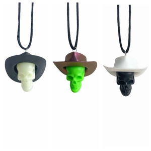 Detailed view of skull cowboy hat pendants in black, brown, and white colors
