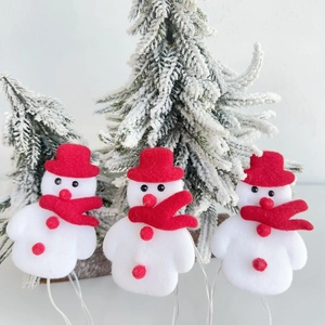 Close-up of Snowman Christmas LED string lights with red hats and scarves on tree