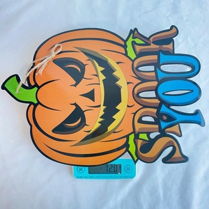 Halloween pumpkin sign weighing 72.0g on a digital scale for material check