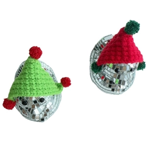 Close-up of disco mirror ducks with festive red and green knitted hats for home decor