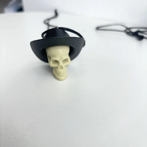Detail of creative skull pendant with black cowboy hat for Halloween party decor