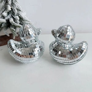 Detail of silver disco mirror ducks showing mosaic glass texture and festive decor