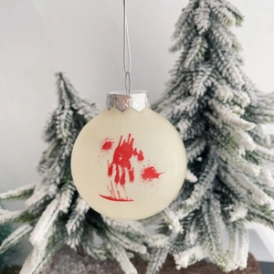 Close-up of Halloween decorative ball with red bloody handprint and snowflake cap