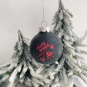 Macro detail of Halloween ornament featuring a bloody handprint and Wanna Play? text
