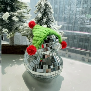 Close-up of disco duck ornament with mirror tiles and red-green Christmas knit hat