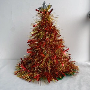 Mini red and gold Christmas tree decoration with a silver star on top and green base